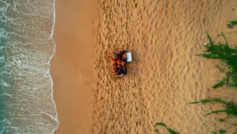 Tourists-sitting-together-at-beach-4k