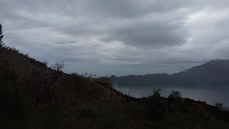 Aerial-revealing-shot-of-Mount-Batur-Volcano-during-cloudy-day-on-Bali-Island