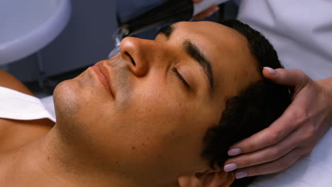 doctor performing laser hair removal on patient face