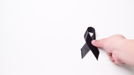 black awareness ribbon on gray background