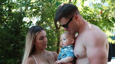 happy family with a baby in a park
