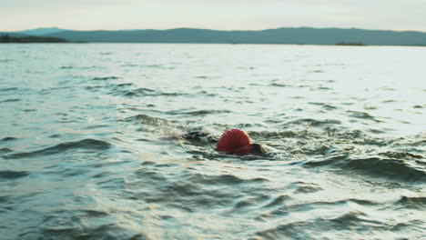 Sportswoman-Swimming-in-Lake-during-Triathlon-Race