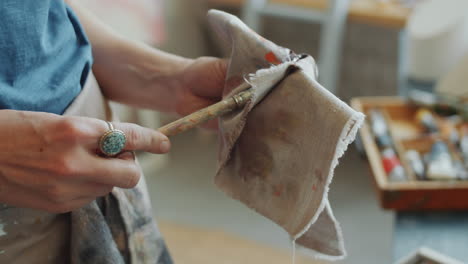 artist cleaning paintbrush