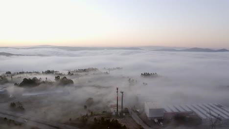 aerial view of a foggy day with low clouds over an industrial area with a highway in portugal