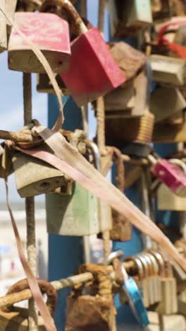 love locks on a fence by the beach