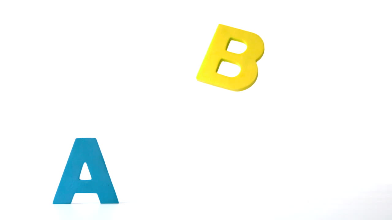 Alphabet magnets lifting off from white surface