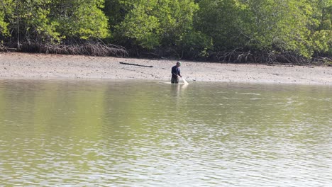 individual angling in tranquil waters near mangroves