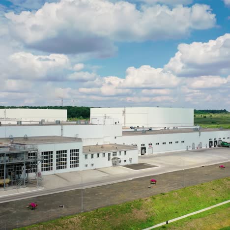 harmful factory in rural place. modern industry near the road on green nature background. large industrial plant on field