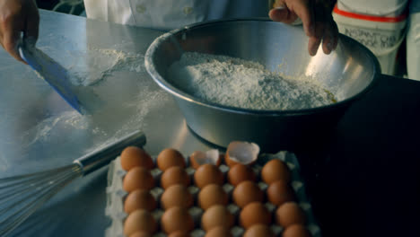 Male-Chef-mixing-egg-and-flour-in-kitchen-4k