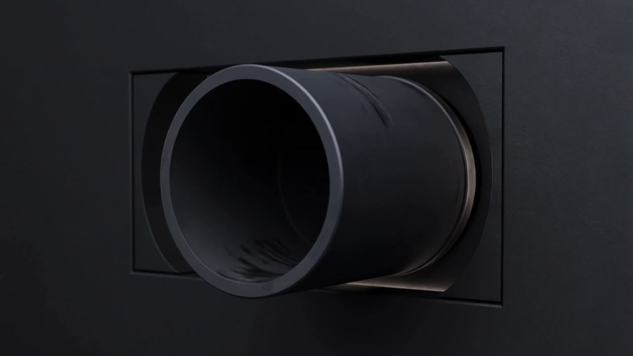 Moving camera forward, showing dark cylindrical tube in black panel, revealing flange detail
