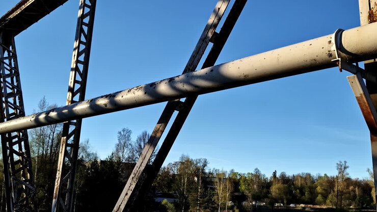 Industrial steel bridge support beams closeup in sunlight