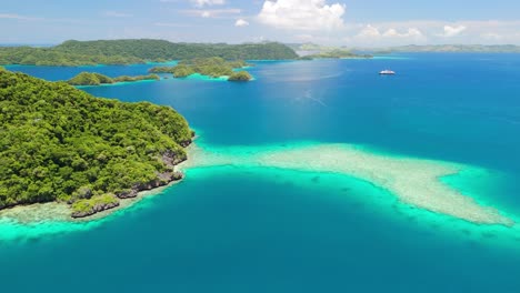 cruise ship anchored in fiji off the edge of coral reef island