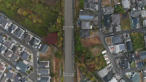Shinkansen-track-top-down-view-surrounded-by-residential-homes-in-Japan