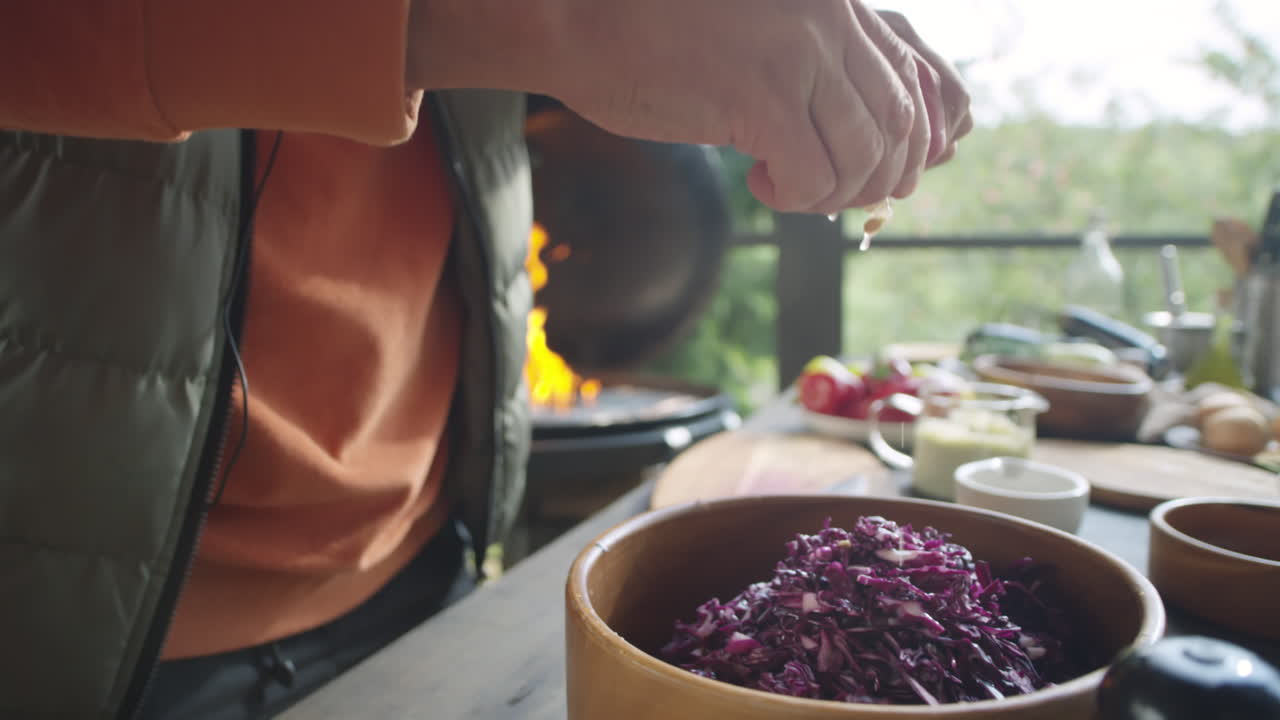 Man Adding Lemon Juice to Shredded Red Cabbage