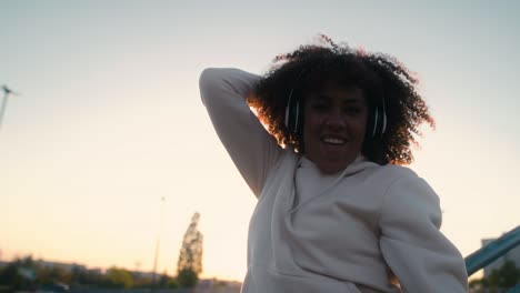 low angle view of black woman dancing on the bridge and looking at camera