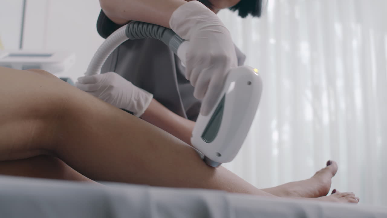 Cosmetologist Giving Laser Epilation Treatment to Client