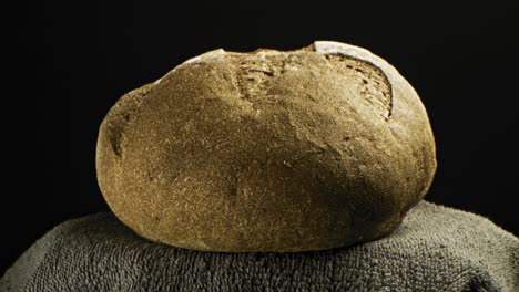 close-up of a dark, rustic loaf of bread