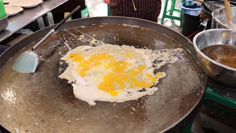 eggs frying on a griddle, cooking process.