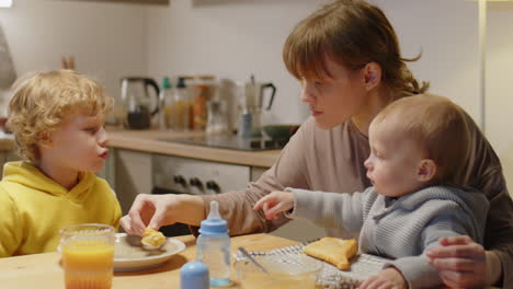 mother and kids having meal at home