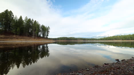 A-Calm,-Still-Lake-in-the-Mountains-of-Montana,-Surrounded-by-Evergreen-Trees,-Motion-Controlled-Timlapse-Pan