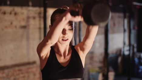 Confident-Sporty-Young-Woman-Exercising-With-Kettlebell-During-Fitness-Training