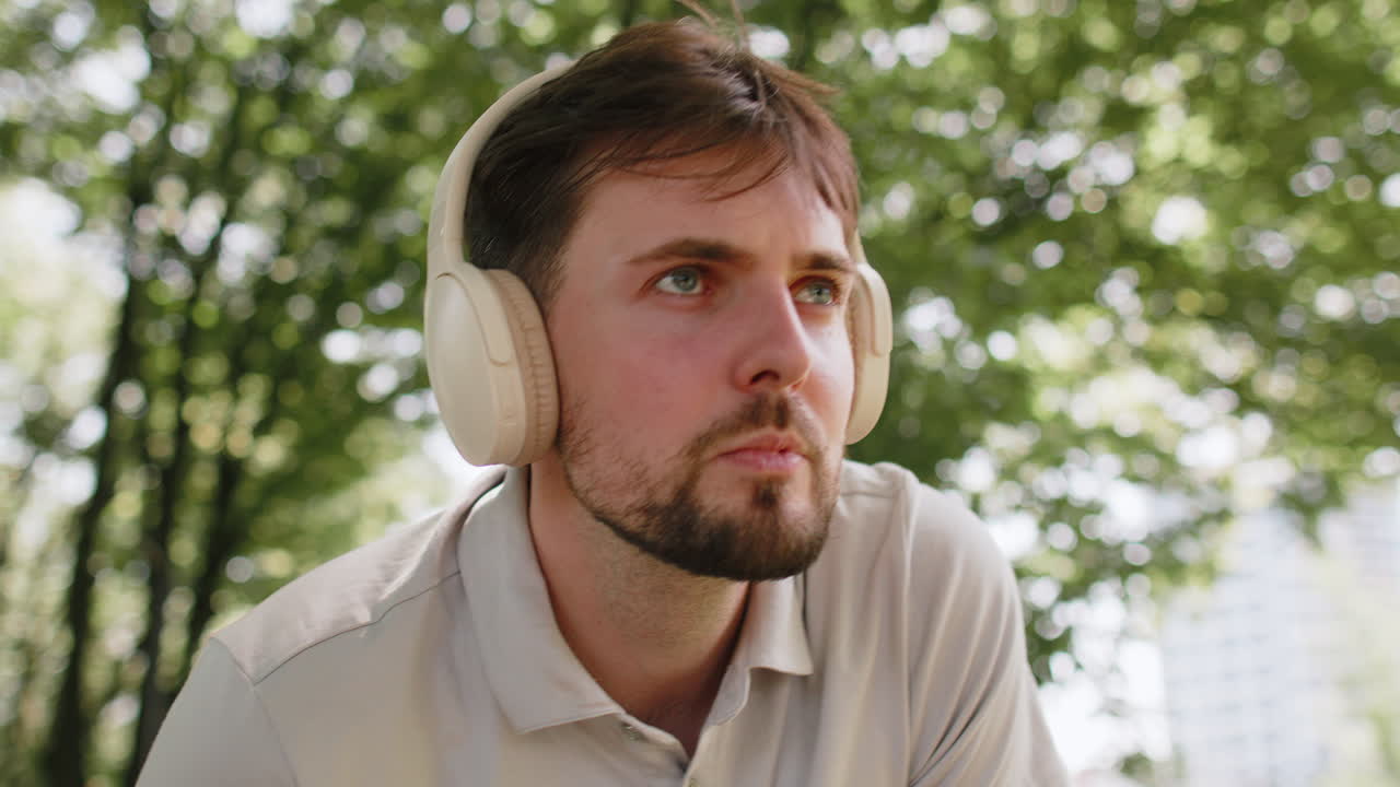 Runner man listening music via wireless headphones using smartwatch for training ready for race