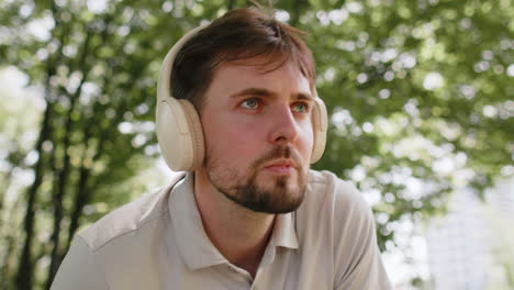 runner man listening music via wireless headphones using smartwatch for training ready for race