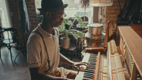a man playing the piano in a stylish cafe