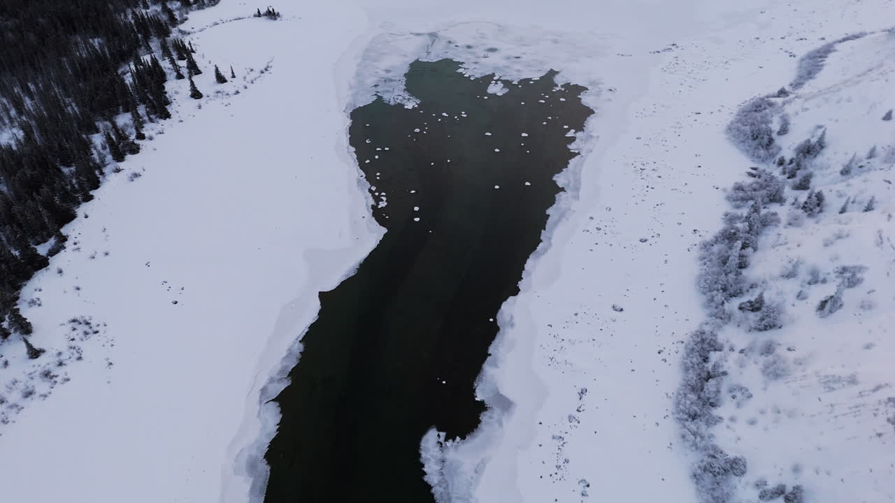 Kusawa Lake Surrounded By Snow On Winter Day In Yukon, Canada. aerial shot
