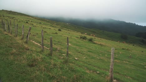 A-car-is-moving-along-a-little-mountain-street,-shot-in-slow-motion-with-a-gimbal