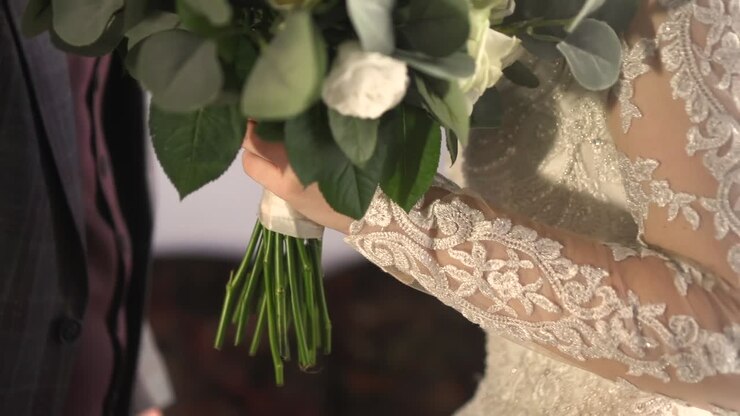 the groom gives the bride a wedding bouquet 01