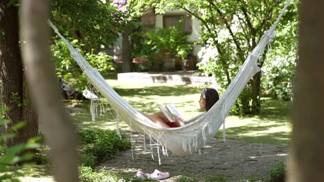 woman relaxing in a garden hammock