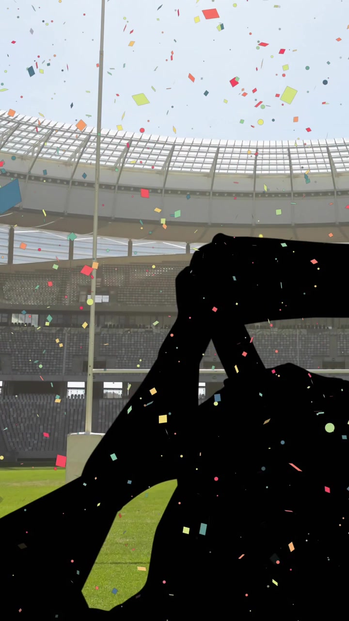 Confeti de colores cayendo contra la silueta de aficionados animando y un estadio deportivo de fondo.