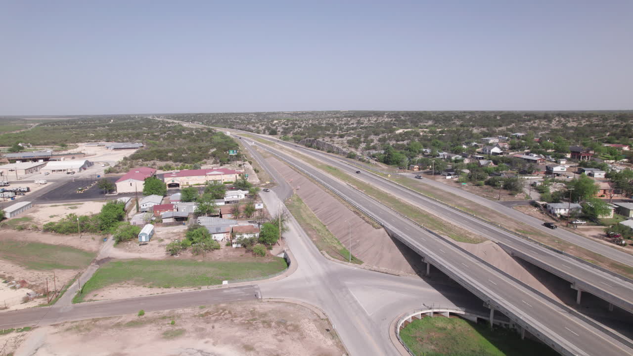 Aerial view of 18 Wheelers and cars on interstate I-10 in Ozona, Texas driving through west Texas