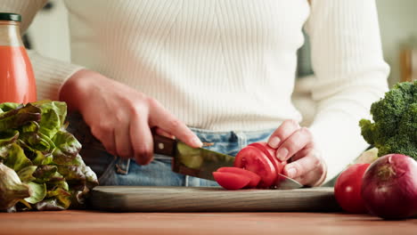 woman cutting tomatoes for a salad