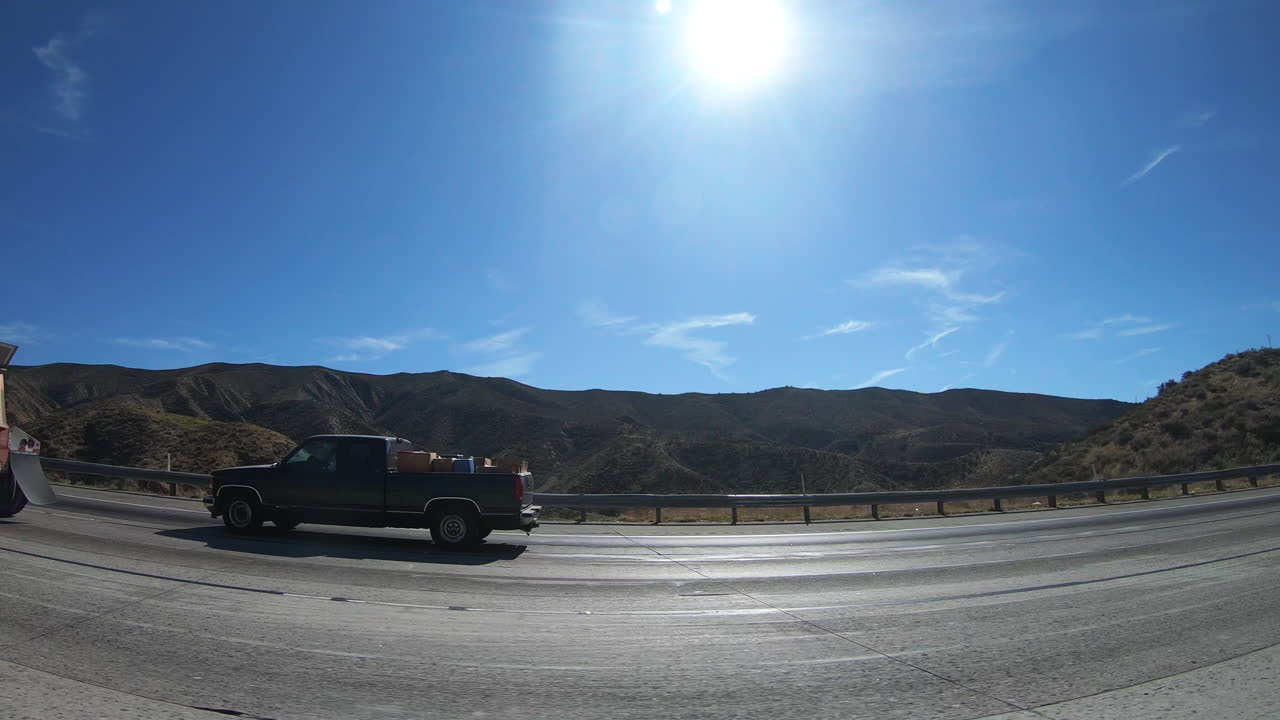 Traveling on the freeway of Los Angeles and passing truckers on the road