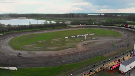 4k drone video of sprint car racing at mitchell raceway in fairbanks, ak during sunny summer evening-12