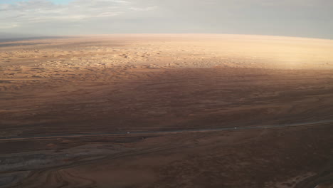 straight road by the salt lake with wide flatlands background.