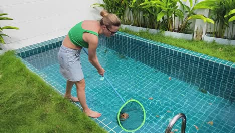 woman cleaning a swimming pool