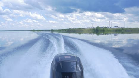 motorboat on a calm lake with cloudy sky