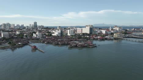 aerial view: warehouses on stilts on waterfront of malaysian city