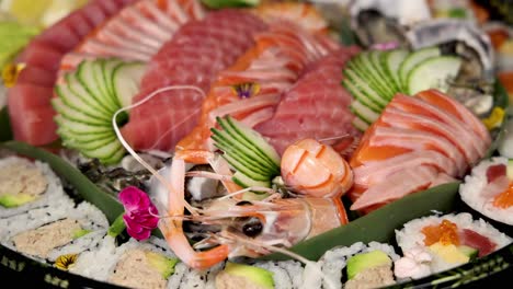 a rotating display of assorted sushi and sashimi