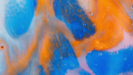 abstract orange and blue liquid watercolor ink colors mixing together