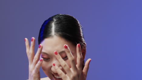 asian woman with black hair and make up covering her face, copy space, slow motion