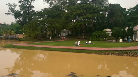 asian people meditating on the grass in the morning in johor bahru, malaysia
