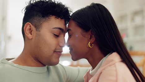 happy couple on couch, kiss in living room of new