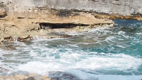 Blaues-Wasser,-Das-Auf-Die-Felsen-Prasselt