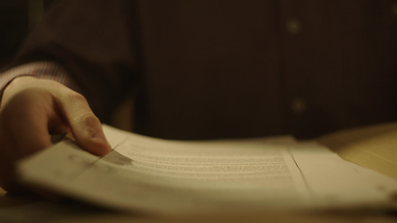 Person Reading Documents at Night