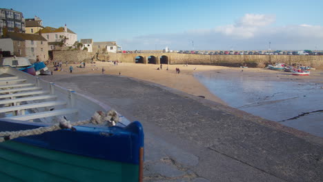 Iconic-Smeatons-Pier-Arches-And-Tourists-On-Sandy-Beach-In-St-Ives,-Cornwall,-UK-On-A-Sunny-Day---wide