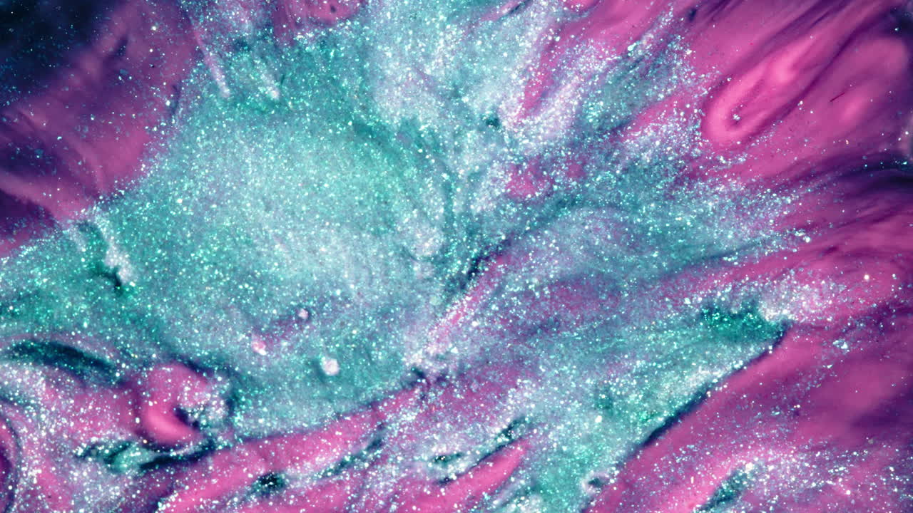 Colorful glitter swirl in macro shot of substances mixing, dreamy and artistic look
